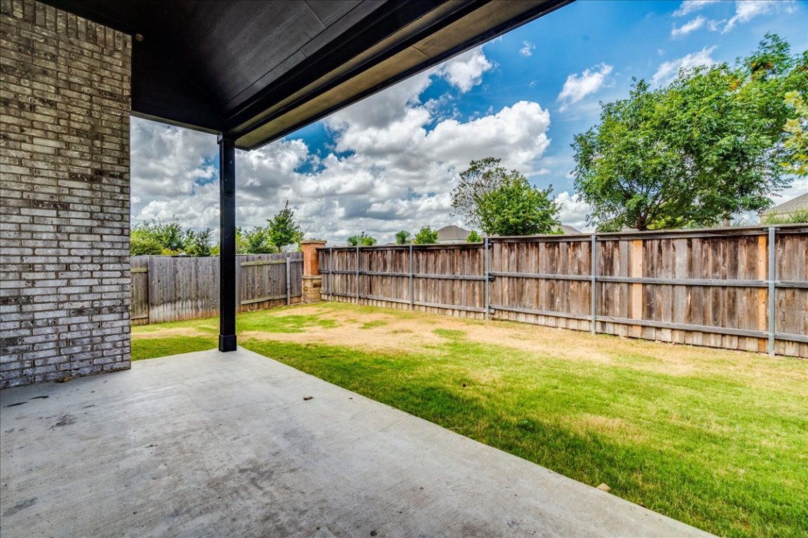 584 Baretta Loop Buda, TX 78610 - Photo 29 of 37 Fenced backyard with a patio area