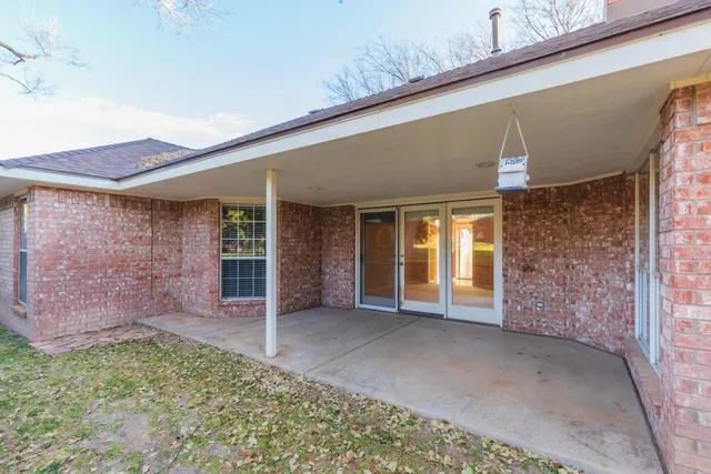 a view of a porch with a table and chairs