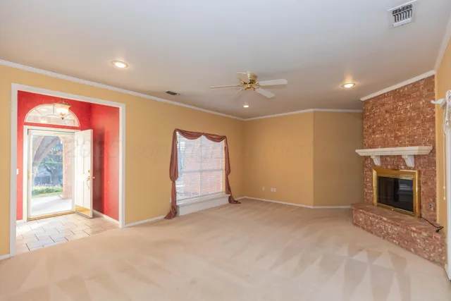 a view of an empty room with a fireplace