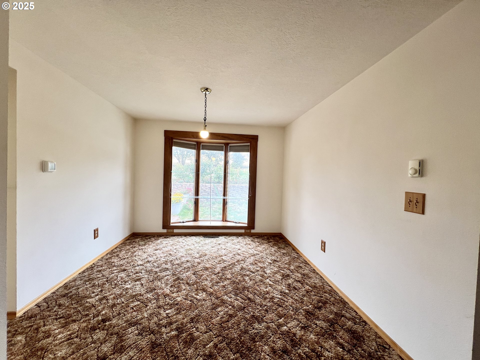 185 Rock Street Heppner, OR 97836 - Photo 12 of 25 a view of an empty room with a window