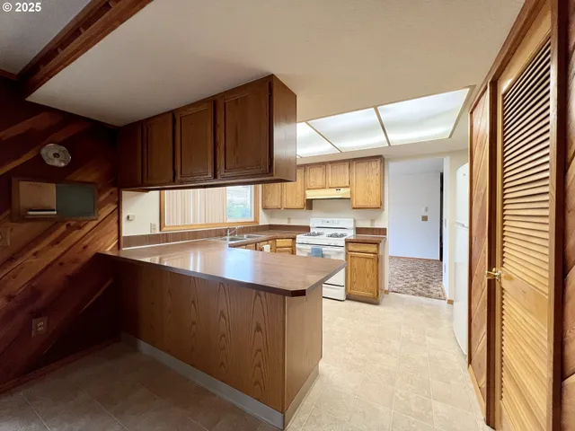 a kitchen with a sink refrigerator and cabinets