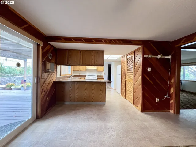 a view of kitchen and refrigerator