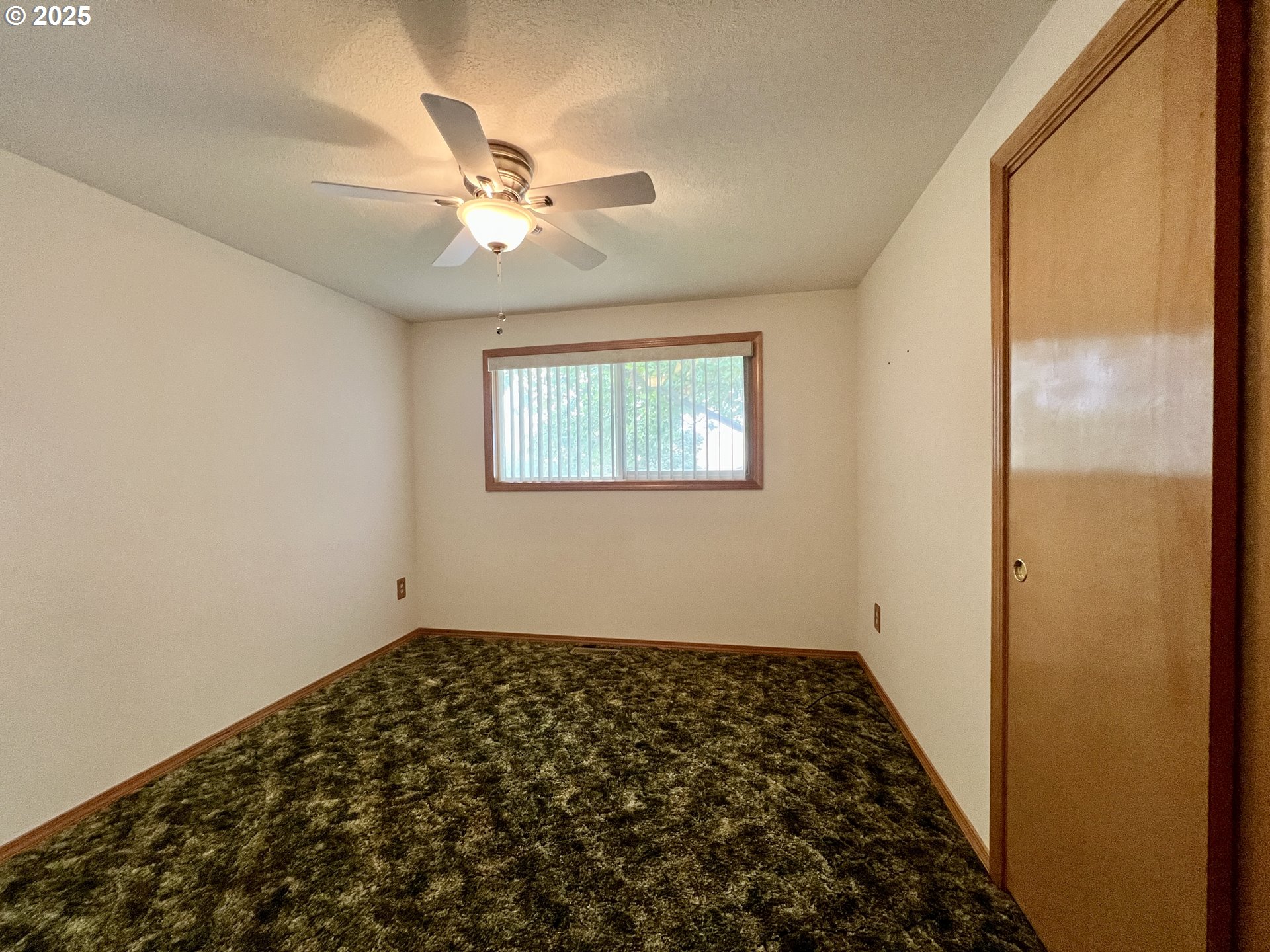 185 Rock Street Heppner, OR 97836 - Photo 23 of 25 a view of a hallway with wooden floor and a chandelier