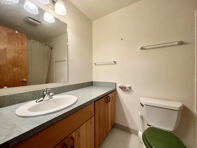 a bathroom with a sink toilet and a mirror