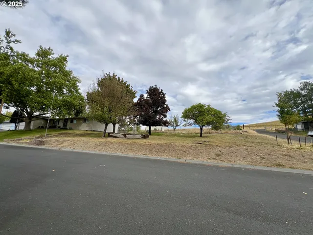 a view of a house with a yard and sitting area