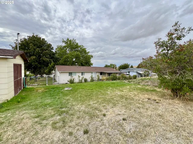 a view of a house with a yard and sitting area