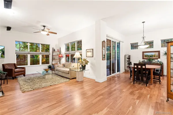 a living room with furniture dining table and a large window