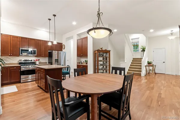 a view of a dining room with furniture wooden floor and chandelier