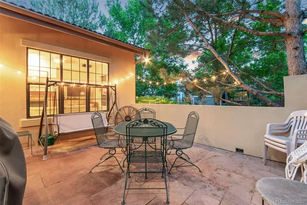 a backyard of a house with table and chairs