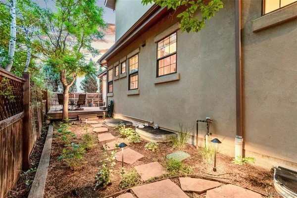 a backyard of a house with table and chairs