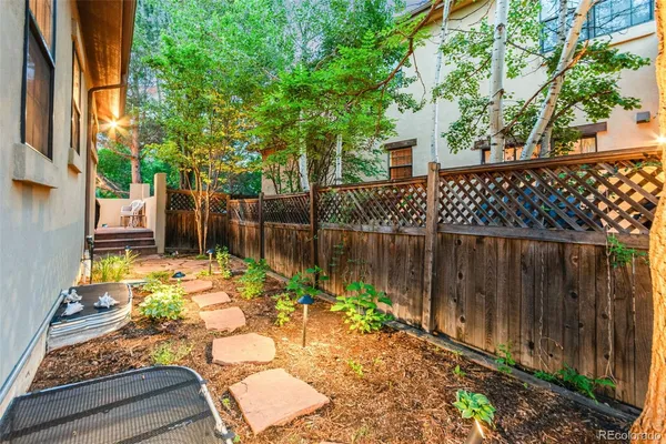 a backyard of a house with lots of green space and plants