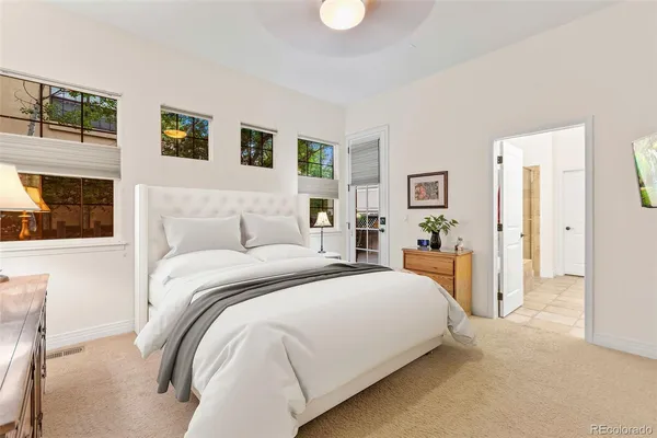 a bedroom with a large bed and a couch