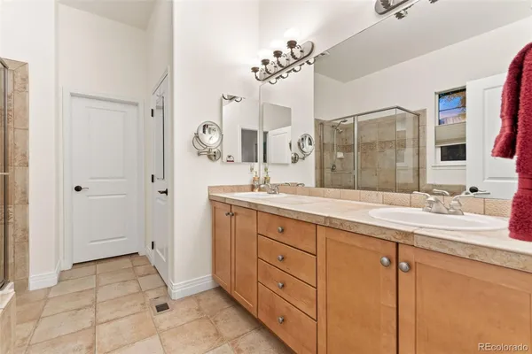 a spacious bathroom with double sink and a mirror