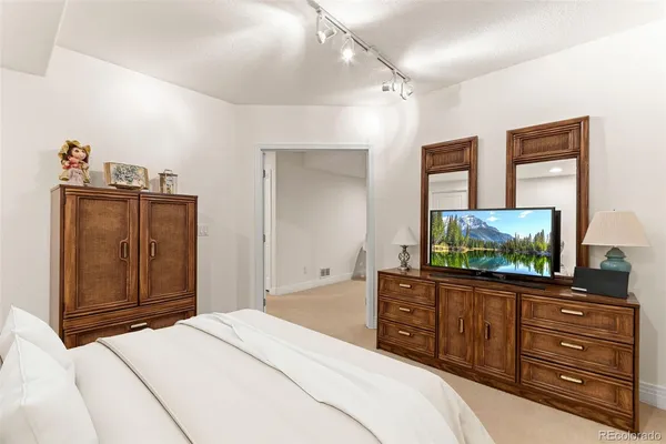 a spacious bathroom with a granite countertop sink a mirror and a shower