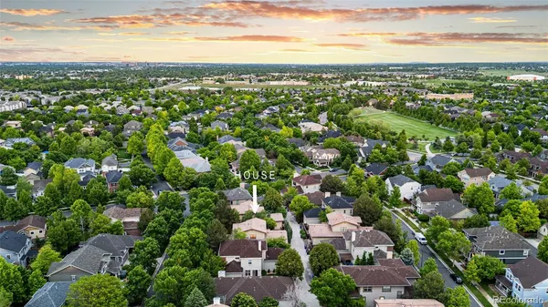 an aerial view of residential houses with city view
