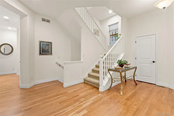 a view of entryway with wooden floor and stairs