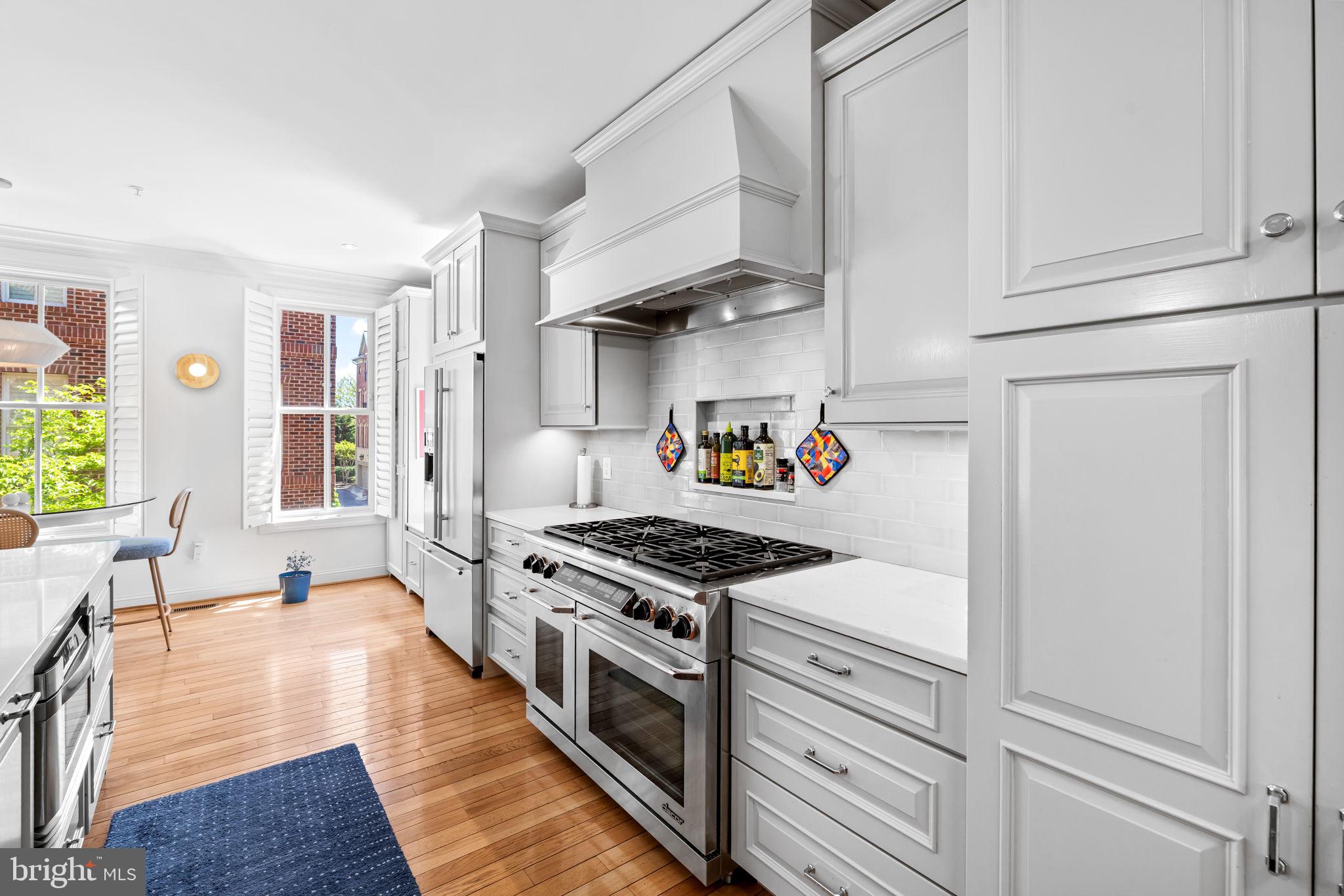 2331 Boston Street, Unit 1 Baltimore, MD 21224 - Photo 26 of 74 a kitchen with stainless steel appliances granite countertop a stove and a refrigerator