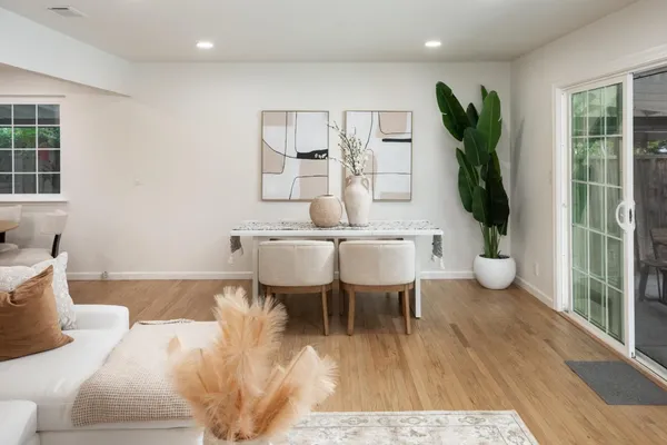 a living room with furniture a wooden floor and a table