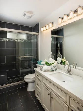 a bathroom with a sink toilet and shower