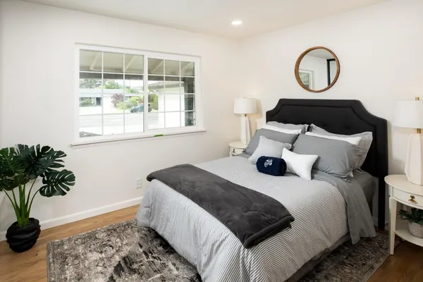 a bedroom with a bed and a potted plant