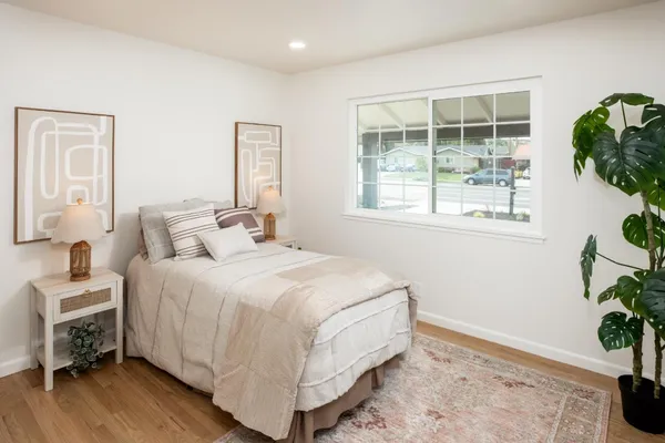a bedroom with a bed and a window