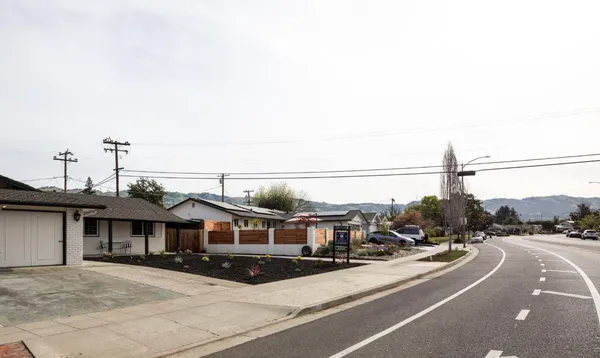 a view of a city street with parked cars