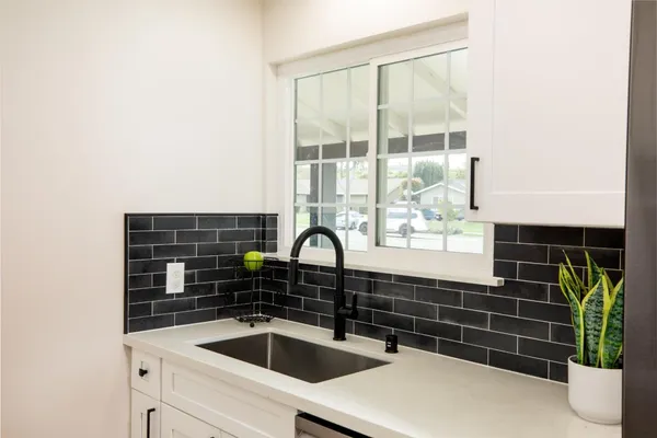 a kitchen with a sink and cabinets