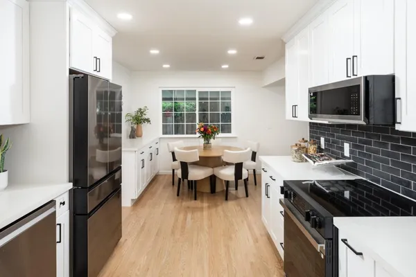 a kitchen with a sink stove and refrigerator