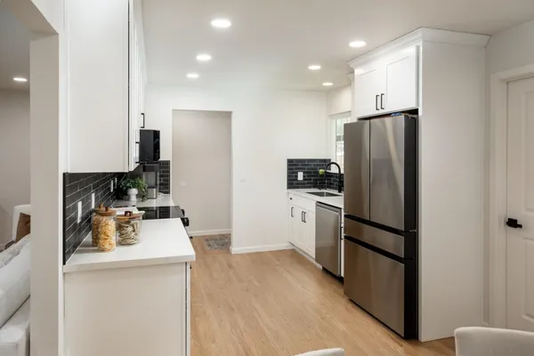 a kitchen with a refrigerator a sink and a stove