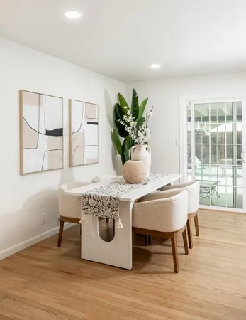 a dining room with furniture and wooden floor