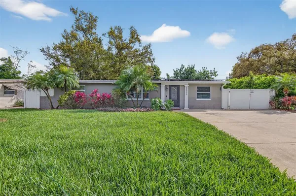 a front view of house with yard and outdoor seating