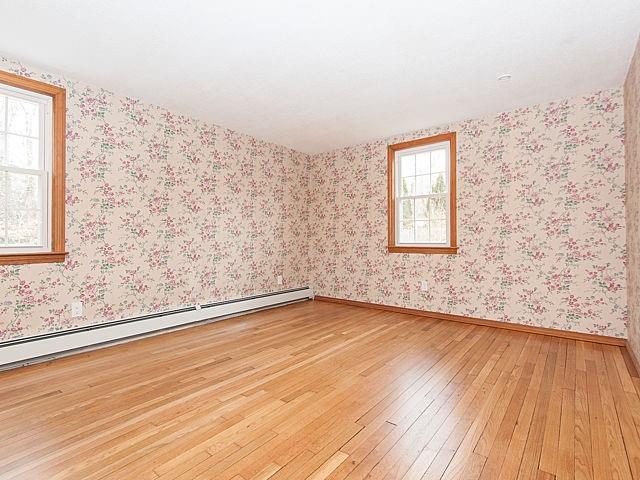 16 Tuckernuck Road Centerville, MA 02632 - Photo 15 of 26 an empty room with wooden floor and windows