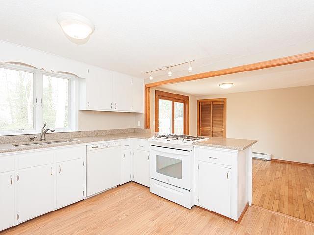 16 Tuckernuck Road Centerville, MA 02632 - Photo 7 of 26 a kitchen with granite countertop white cabinets and white appliances