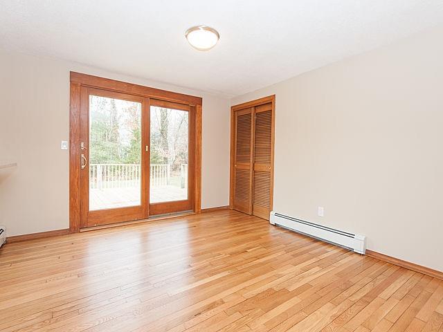 16 Tuckernuck Road Centerville, MA 02632 - Photo 8 of 26 an empty room with wooden floor and windows
