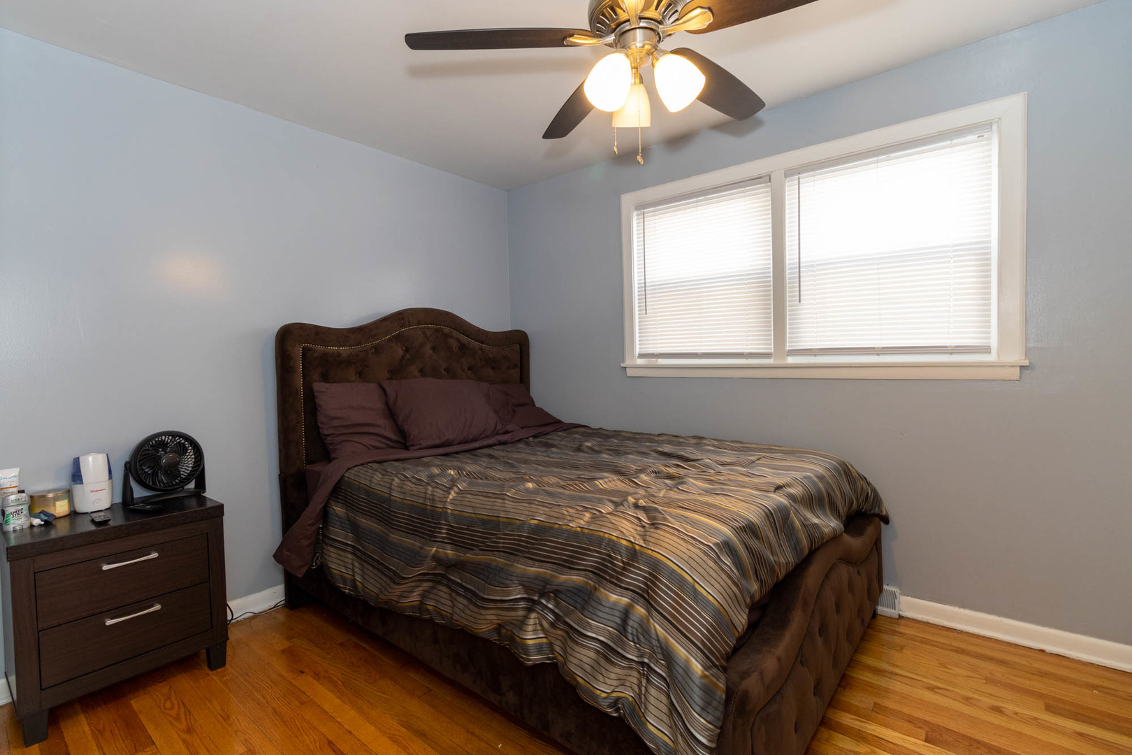 9951 South Perry Avenue Chicago, IL 60628 - Photo 11 of 27 a bedroom with a bed and a window