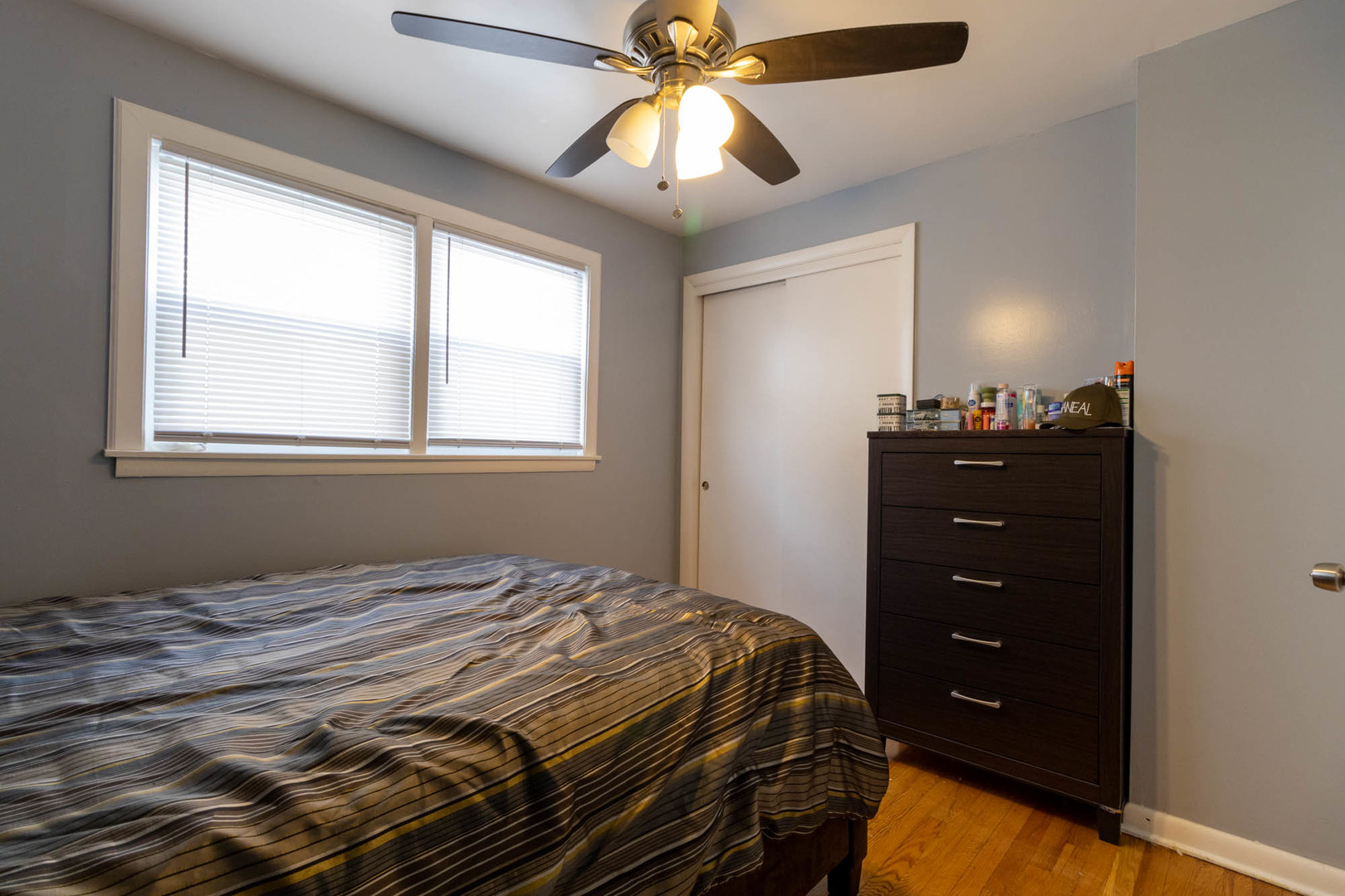 9951 South Perry Avenue Chicago, IL 60628 - Photo 12 of 27 a bedroom with a bed and a chandelier