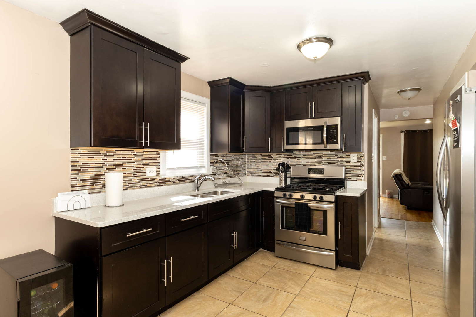 9951 South Perry Avenue Chicago, IL 60628 - Photo 14 of 27 a kitchen with a sink stove and refrigerator