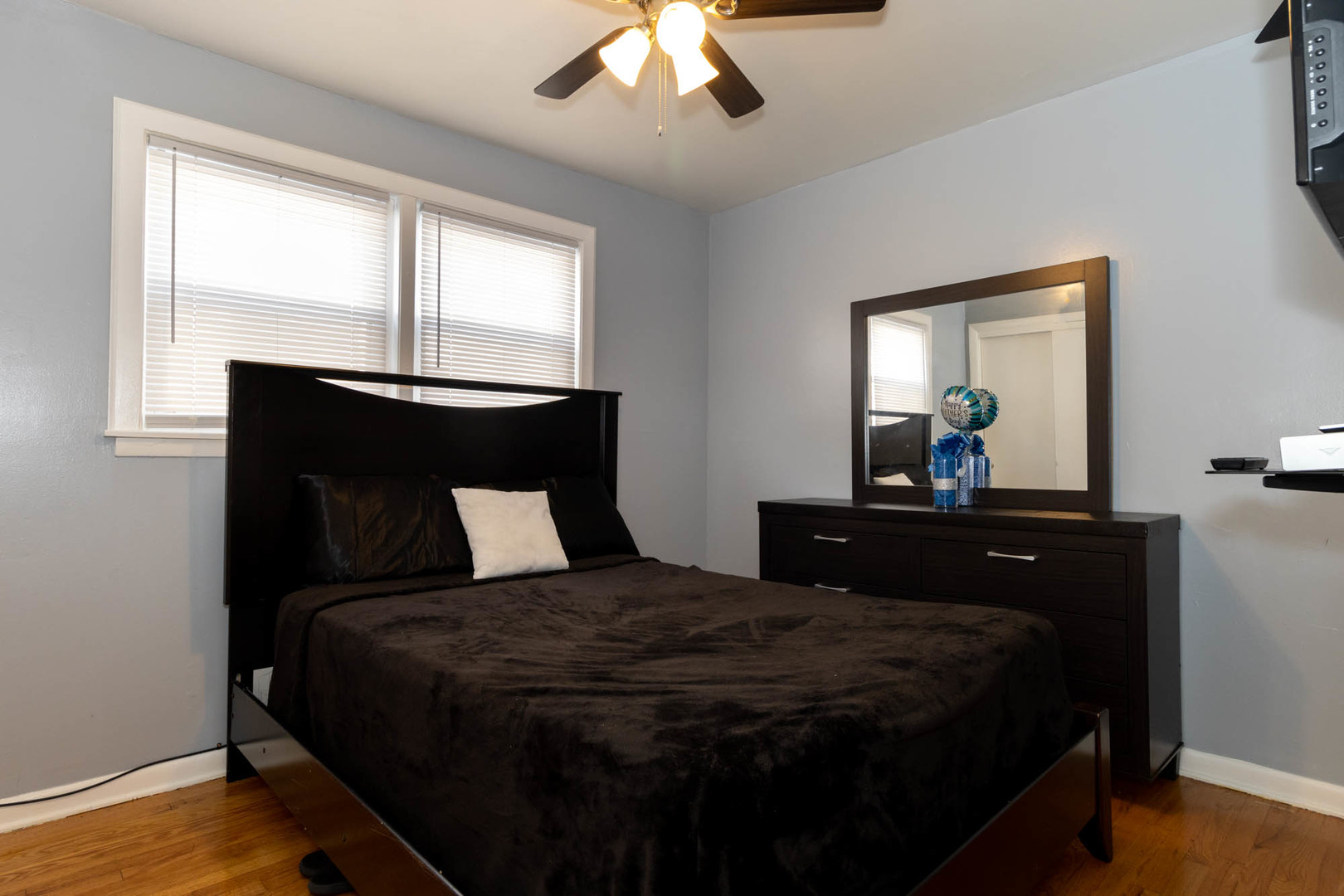 9951 South Perry Avenue Chicago, IL 60628 - Photo 16 of 27 a bedroom with a bed and a mirror