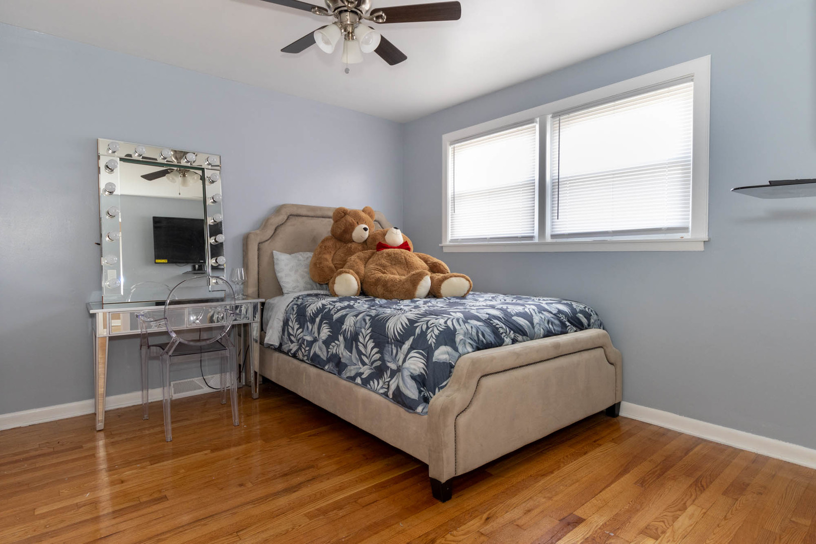 9951 South Perry Avenue Chicago, IL 60628 - Photo 19 of 27 a bedroom with a bed and a chandelier
