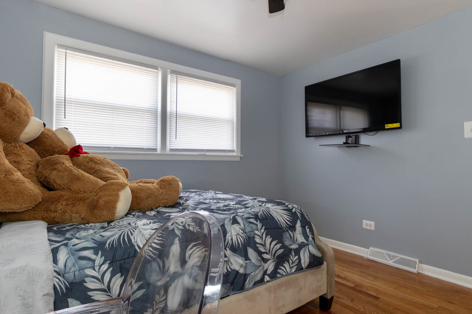 9951 South Perry Avenue Chicago, IL 60628 - Photo 21 of 27 a bedroom with a bed and a flat screen tv