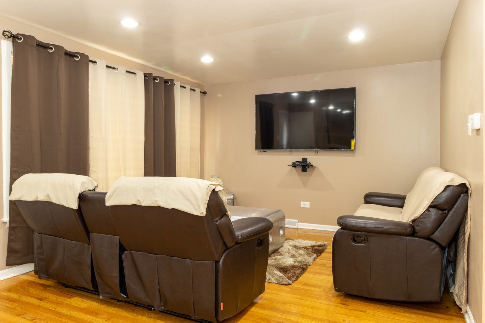9951 South Perry Avenue Chicago, IL 60628 - Photo 5 of 27 a living room with furniture and a flat screen tv