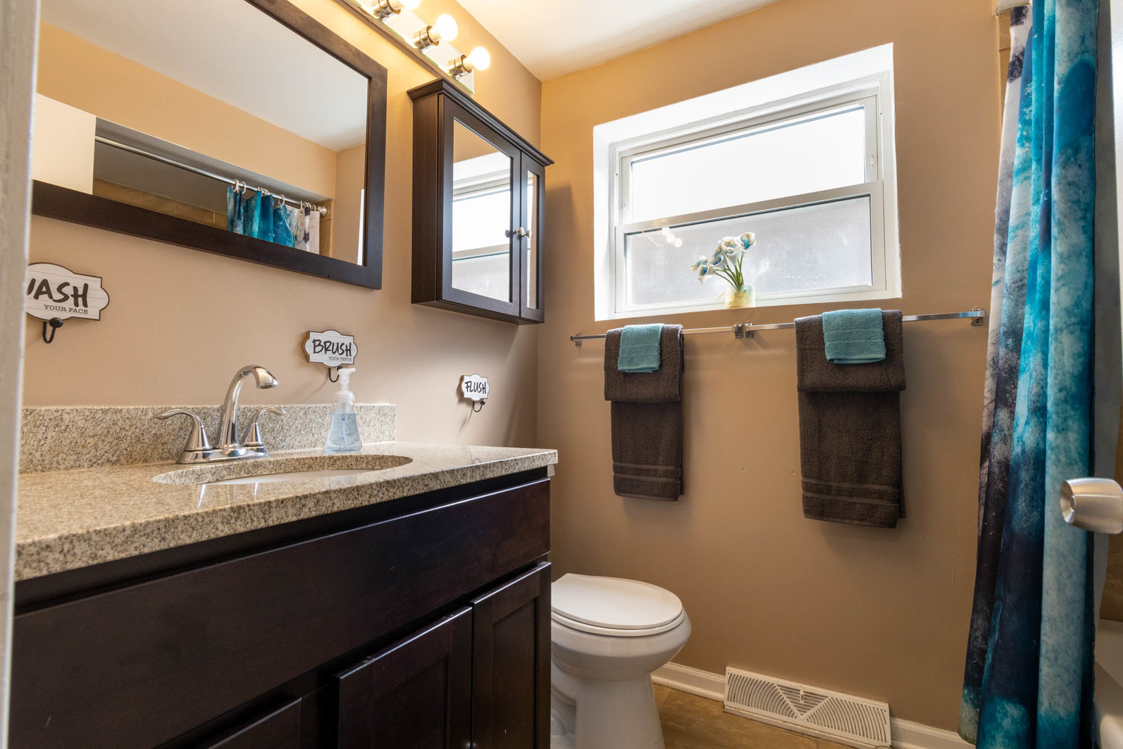 9951 South Perry Avenue Chicago, IL 60628 - Photo 8 of 27 a bathroom with a sink a toilet and mirror