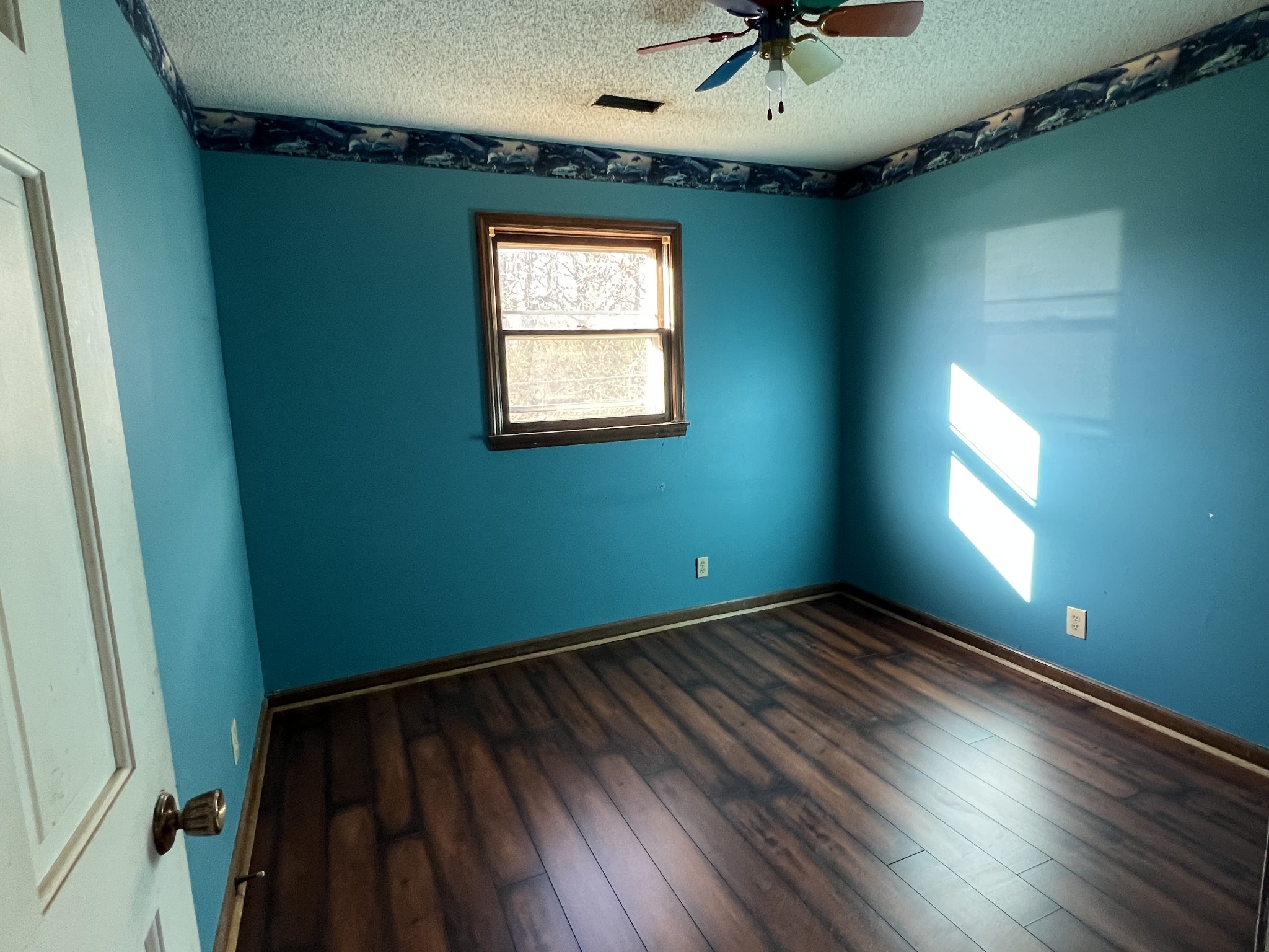 401 Hillcrest Road Manchester, TN 37355 - Photo 15 of 16 an empty room with a window and a ceiling fan