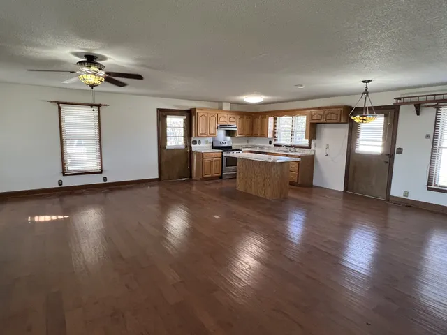 a view of a livingroom with furniture wooden floor and chandelier