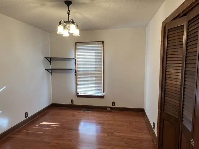 a view of a room with wooden floor and windows