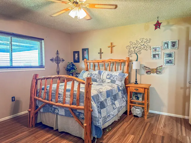 a bedroom with furniture and wooden floor