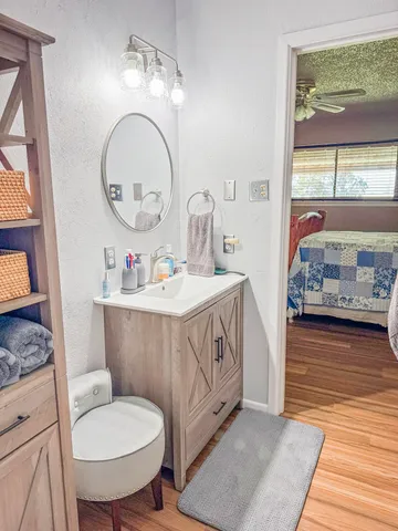 a bathroom with a toilet a sink and a mirror