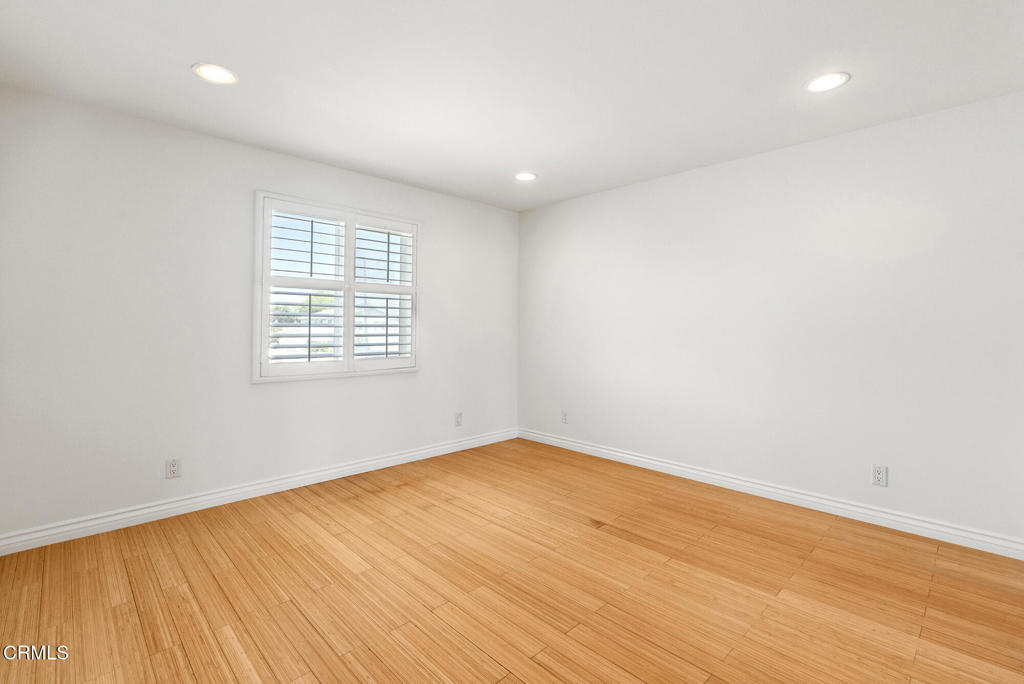 2546 Commerce Way Commerce, CA 90040 - Photo 25 of 53 an empty room with wooden floor and windows