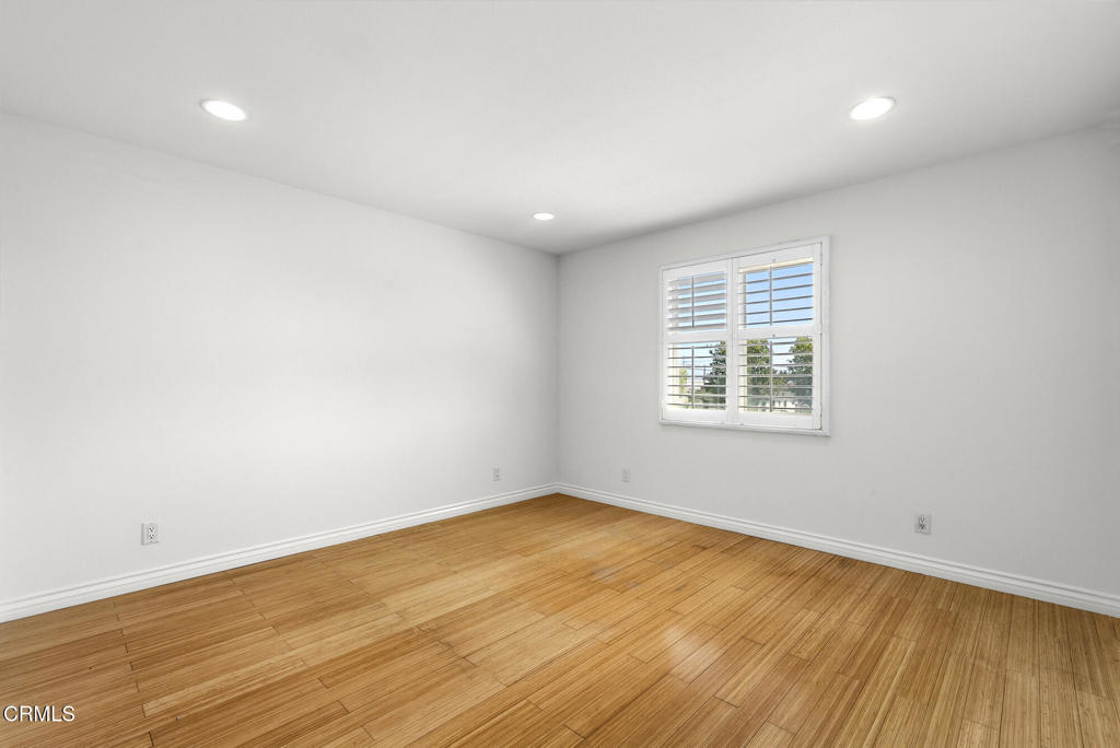 2546 Commerce Way Commerce, CA 90040 - Photo 28 of 53 an empty room with wooden floor and windows