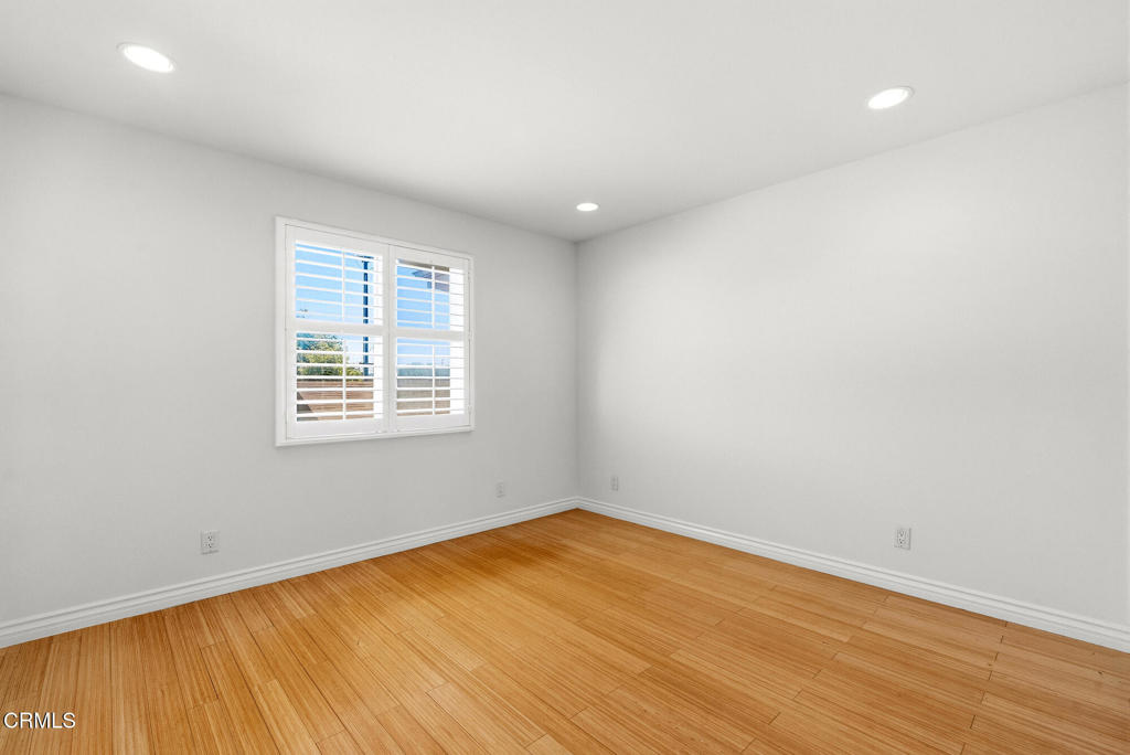 2546 Commerce Way Commerce, CA 90040 - Photo 30 of 53 an empty room with wooden floor and windows